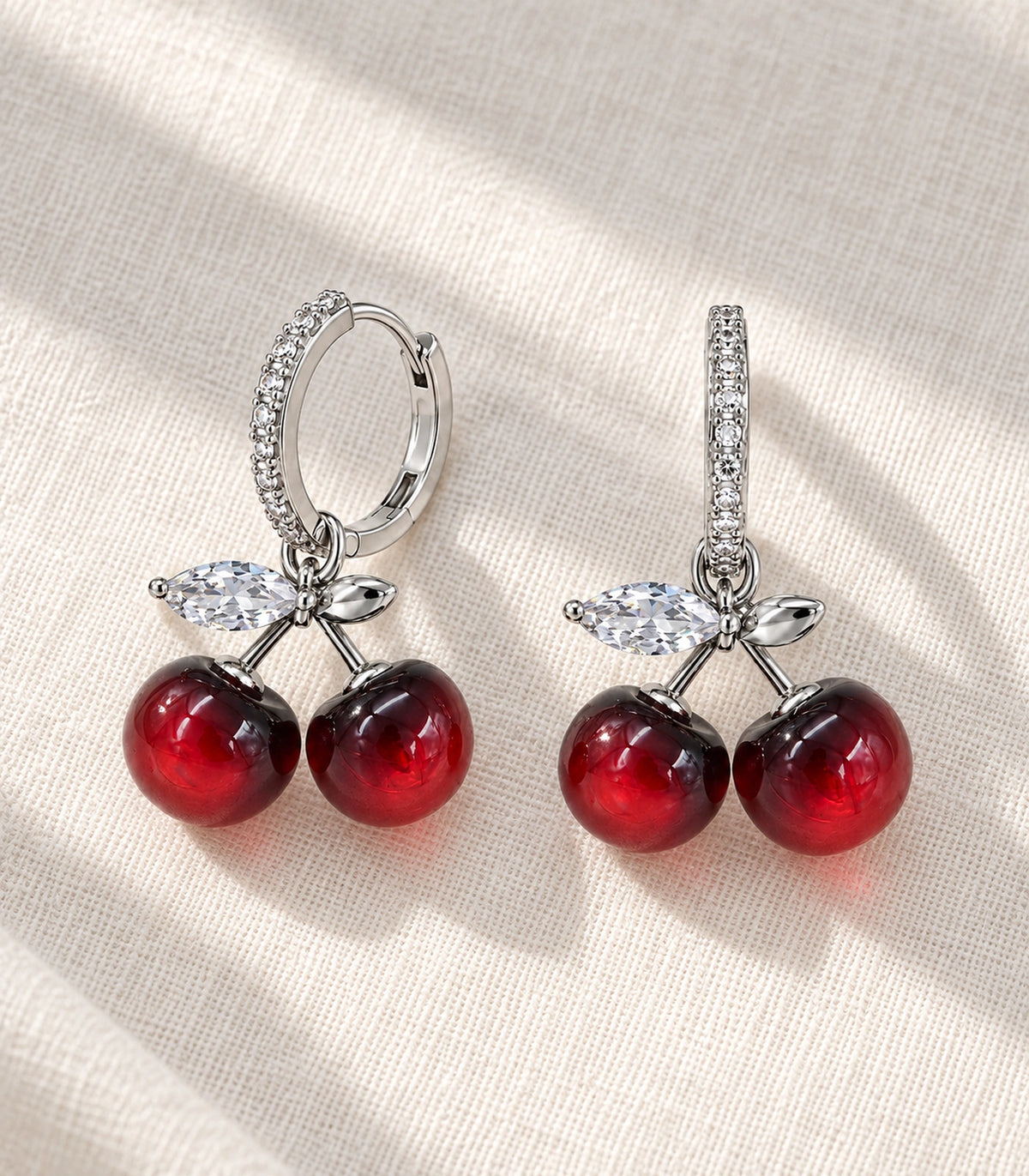 JIMIKI Cherry Crystal Leaf Hoop Earring Pair in Silver-tone / Red / Clear, editorial flat lay #color_silver-tone / red / clear