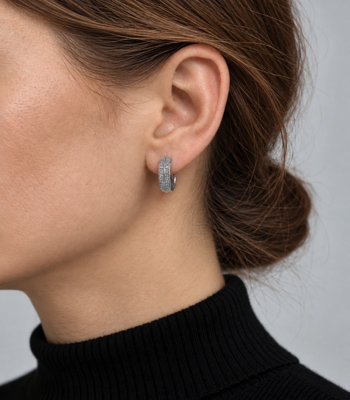 JIMIKI ridged pave hinged hoop earring pair in silver tone, worn on a model #color_silver tone