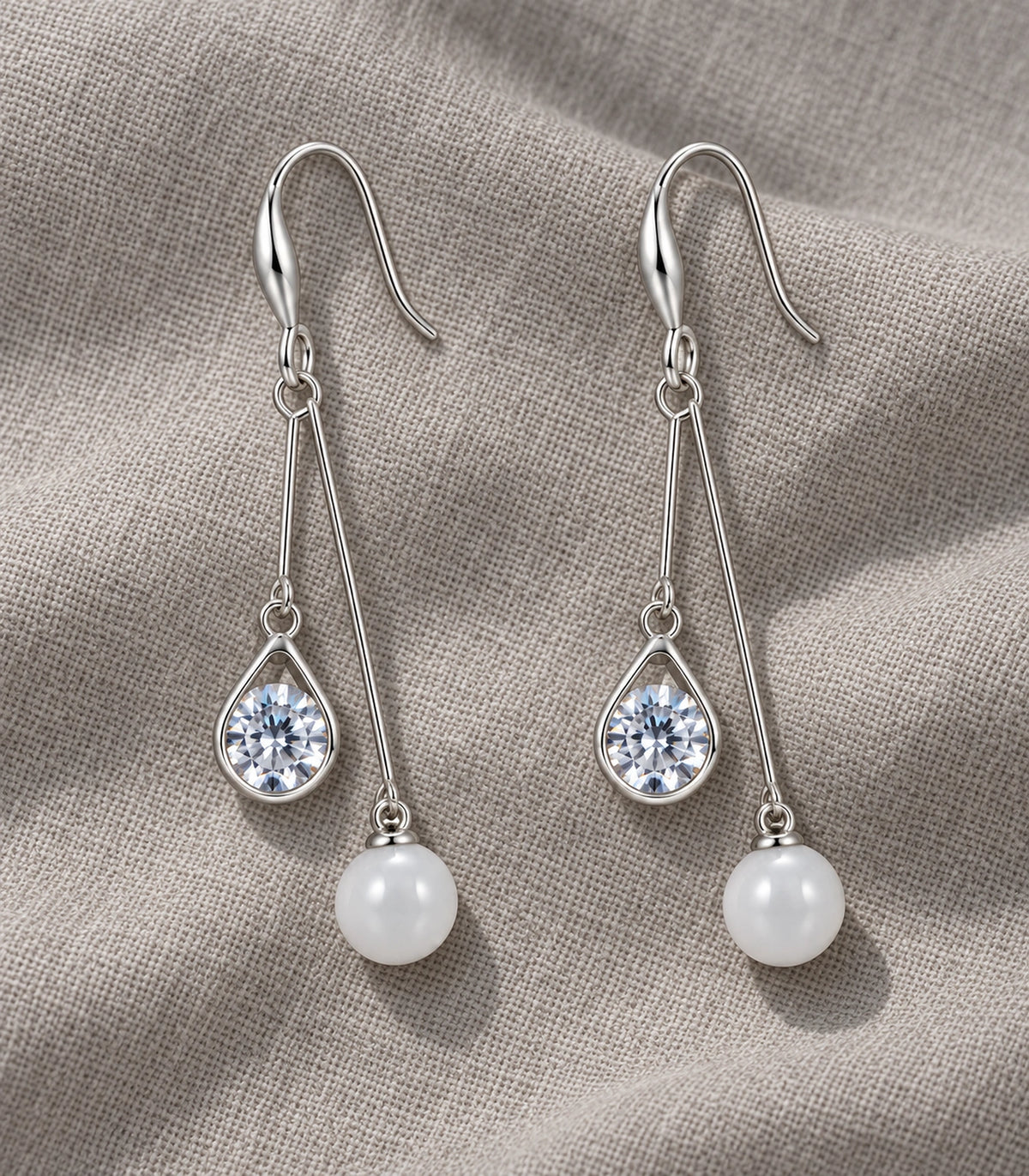 JIMIKI Silver-Tone Round Crystal Pearl Twin Wire Drop Earrings in Silver Tone, editorial flat lay