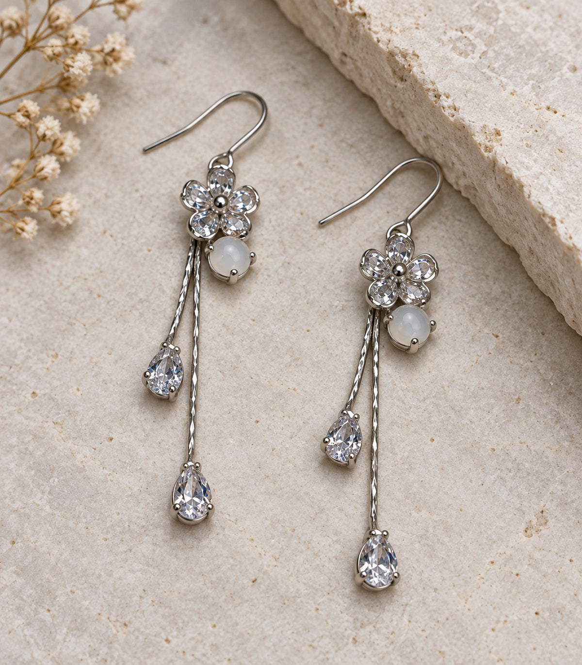 JIMIKI Silver Tone Rounded Flower White Stone Twin Pear Earring Pair in Silver-tone, editorial flat lay