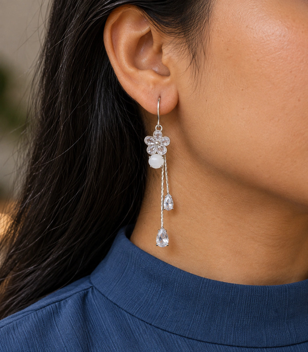JIMIKI Silver Tone Rounded Flower White Stone Twin Pear Earring Pair in Silver-tone, editorial model view