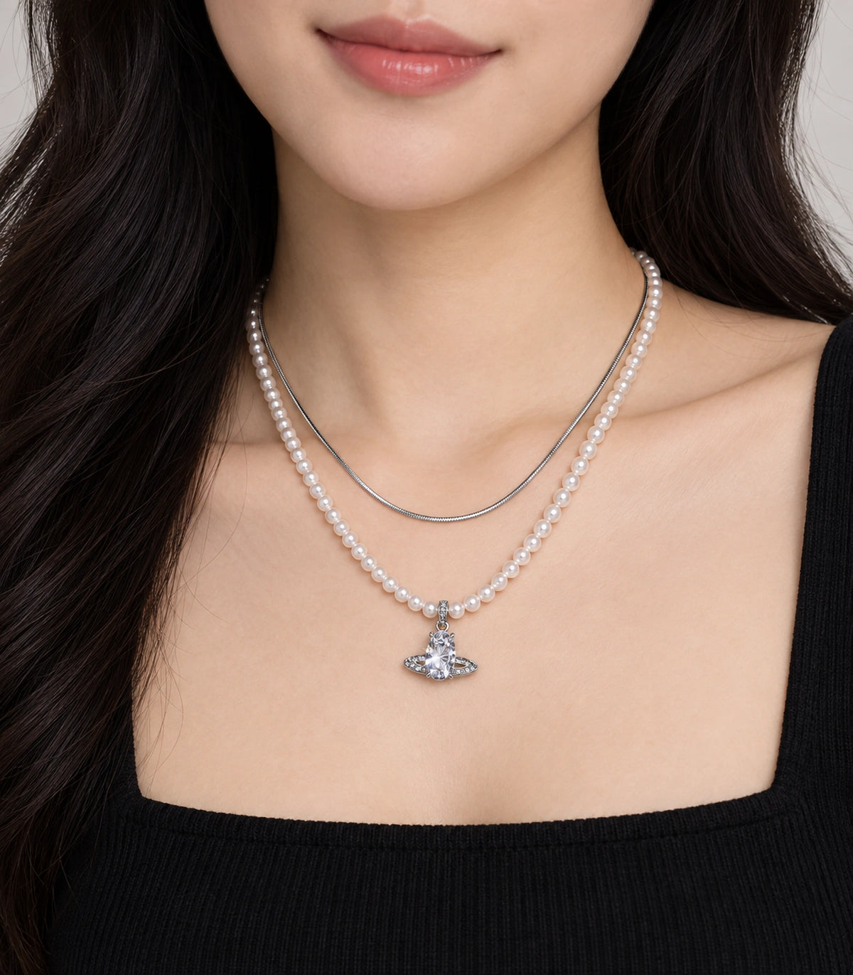 JIMIKI Silver-Tone Saturn Layered Pearl Necklace Set in Silver-tone / clear / white, worn with a simple outfit
