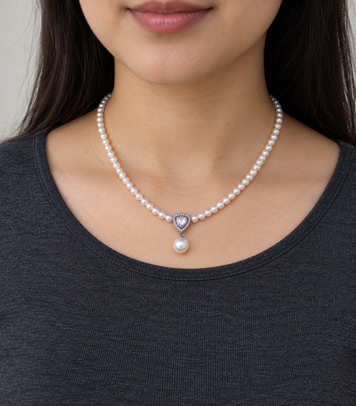 JIMIKI Silver Tone Shield Crystal Pearl Drop Necklace in Silver / White, model wearing view