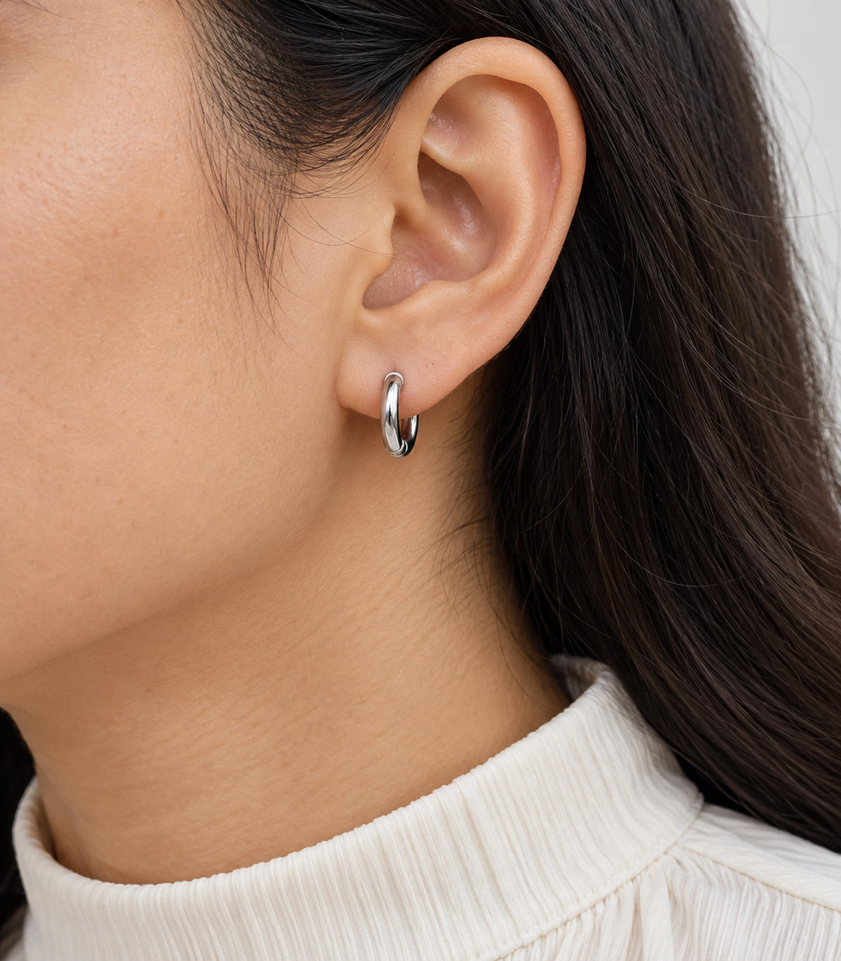 Silver Tone Smooth Huggie Hoop Earring — close detail of smooth hoop and hinge