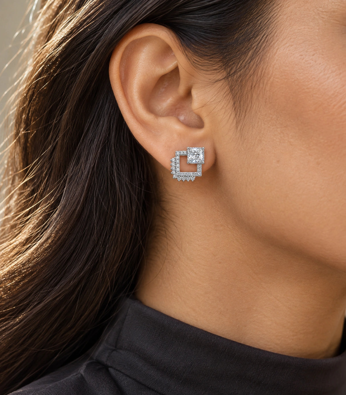 JIMIKI Silver Tone Square Crystal Open Square Stud Earring Pair in Silver tone / clear, editorial model view