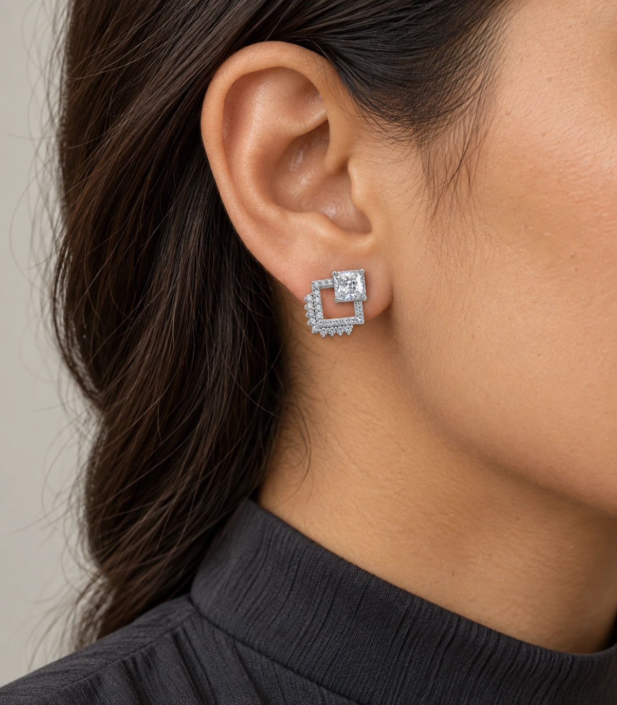 JIMIKI Silver Tone Square Crystal Open Square Stud Earring Pair in Silver tone / clear, model wearing view