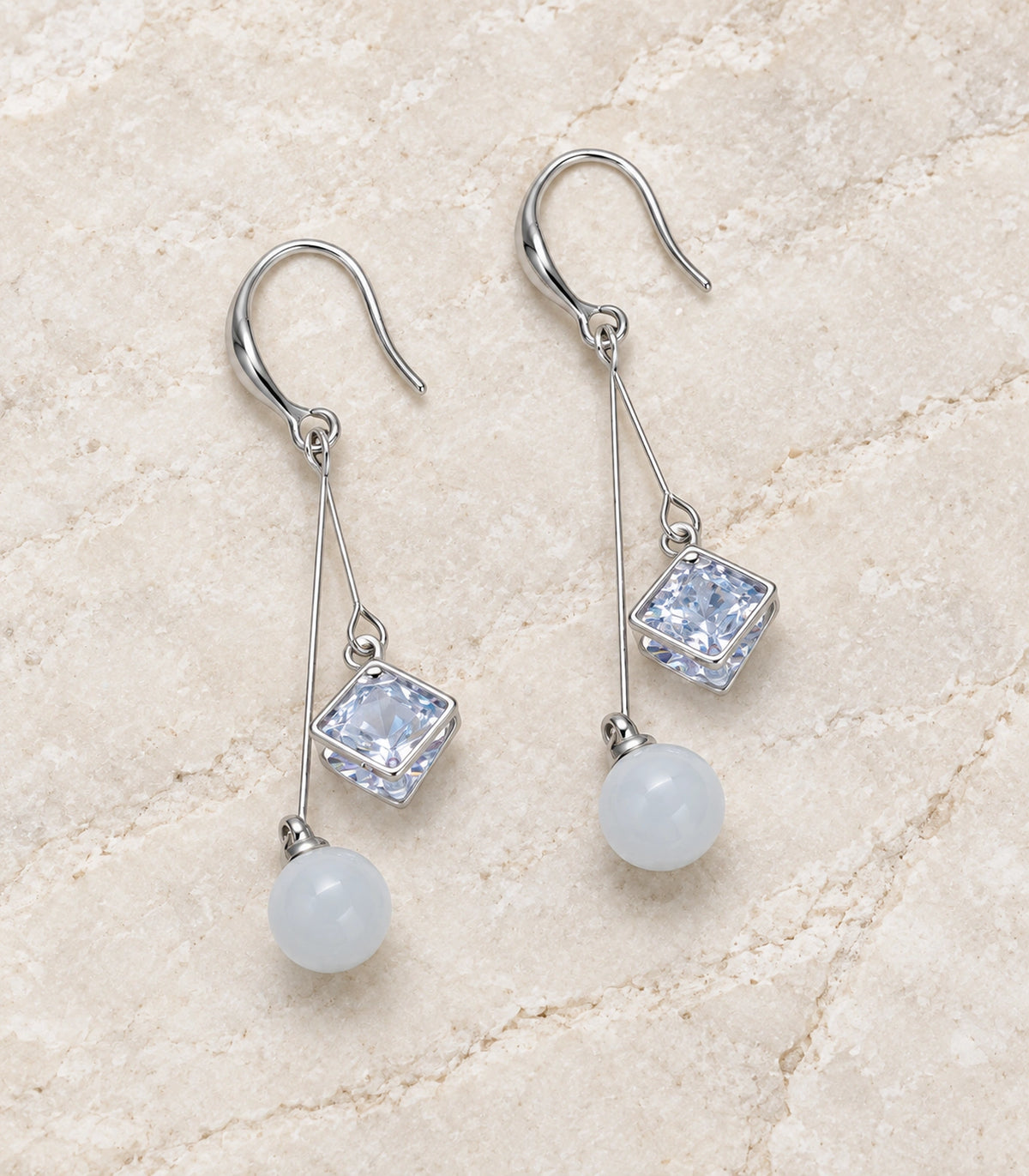 JIMIKI Silver Tone Square Crystal White Bead Wire Drop Earring Pair in Silver-tone, editorial flat lay