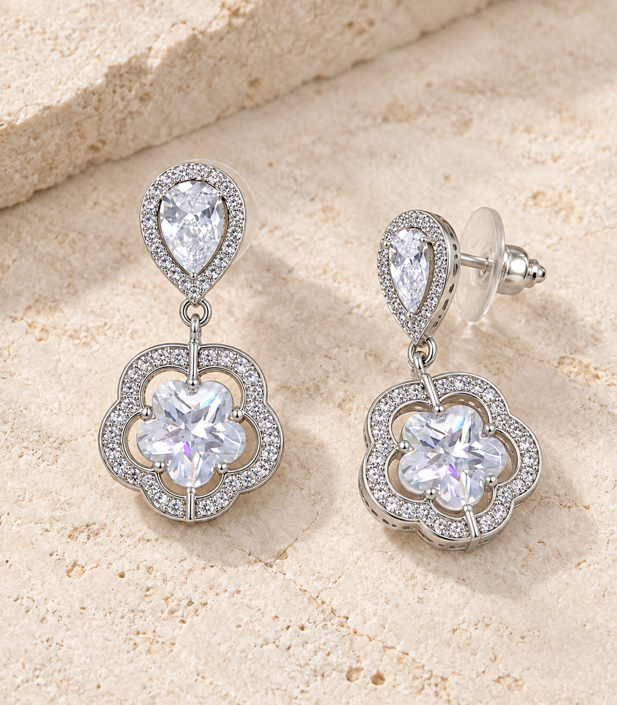 JIMIKI Teardrop Flower Crystal Drop Earring Pair in Silver-tone, editorial flat lay #color_silver-tone