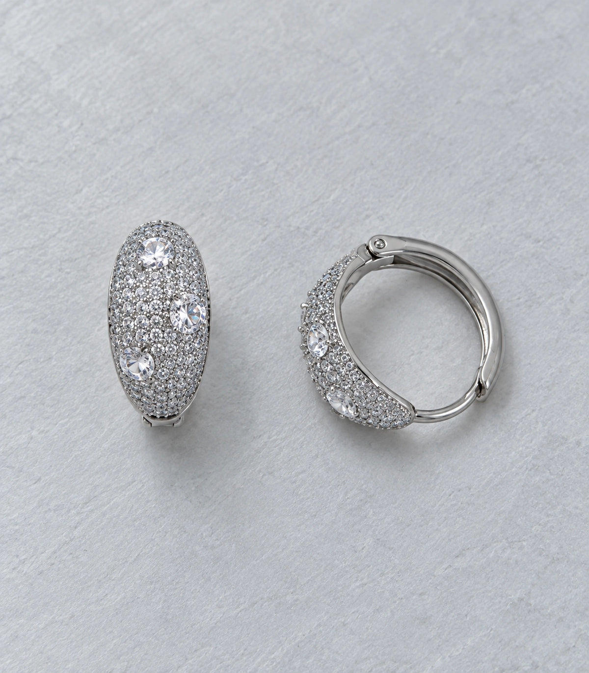 JIMIKI Three Crystal Domed Pave Hoop Earring Pair in Silver Tone, editorial flat lay #color_silver tone