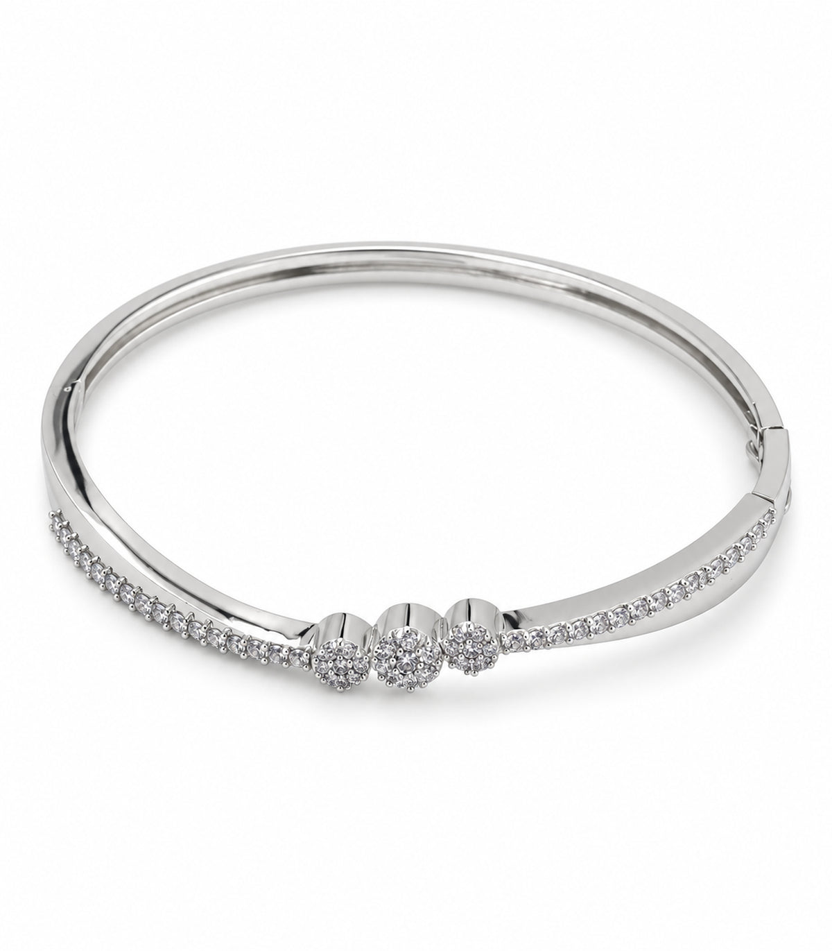 Silver-tone hinged bangle with three crystal flower clusters on white background