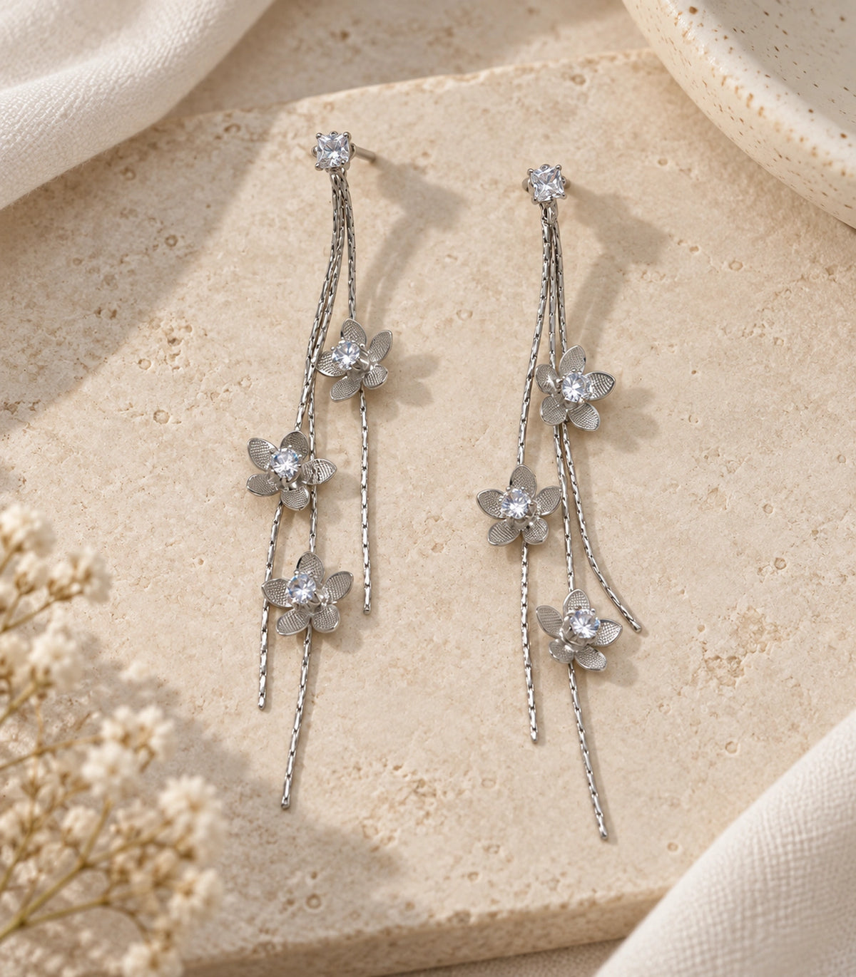 JIMIKI Silver Tone Three Flower Triple Chain Stud Earring Pair in Silver-tone, editorial flat lay