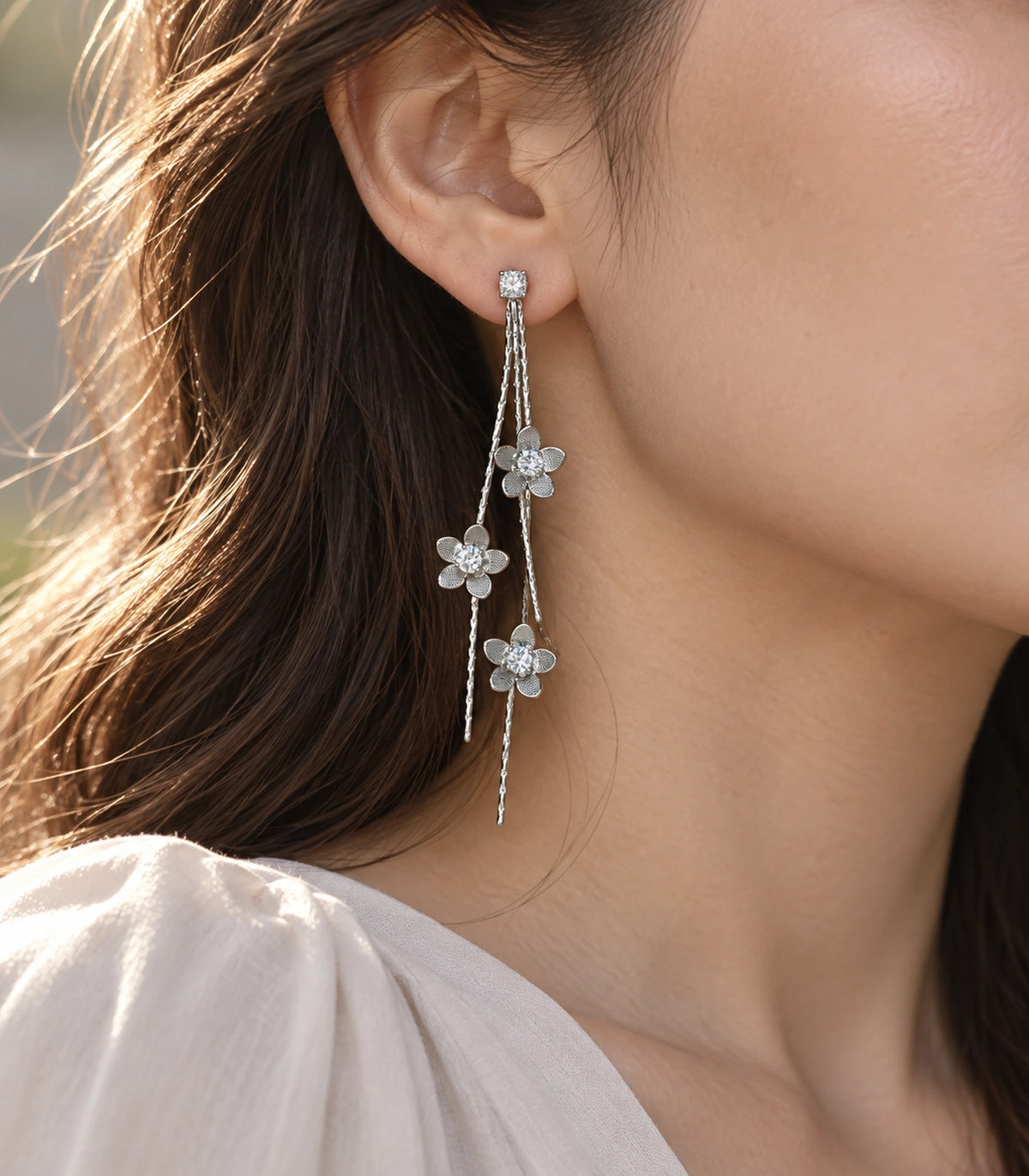 JIMIKI Silver Tone Three Flower Triple Chain Stud Earring Pair in Silver-tone, editorial model view
