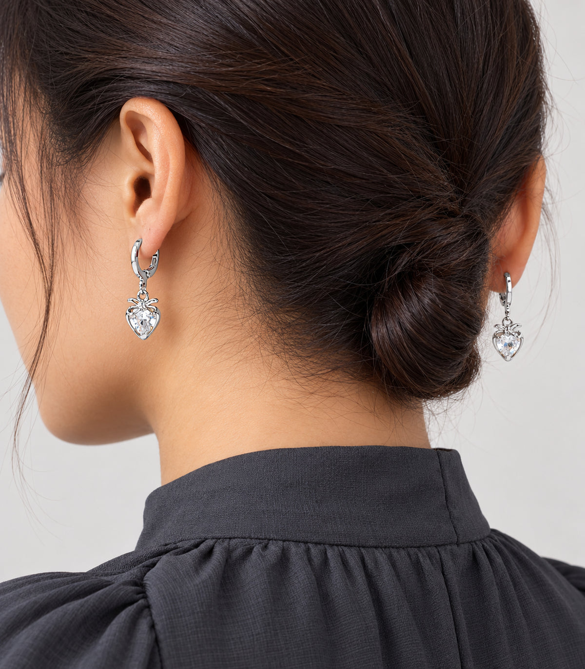 Silver-tone hoop earrings from the three-pair set shown worn