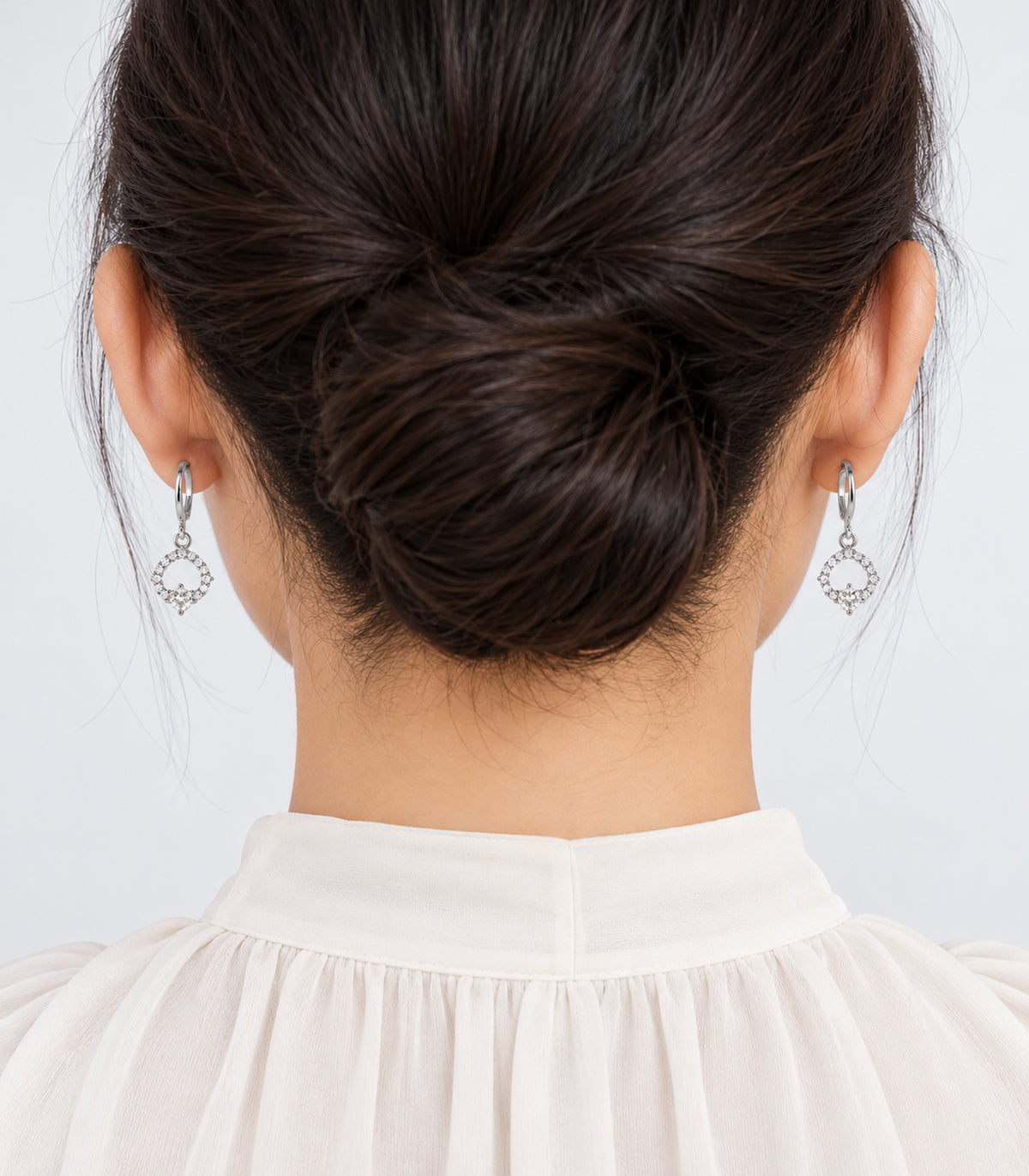 Worn pair from the silver-tone three-pair geometric hoop earring set