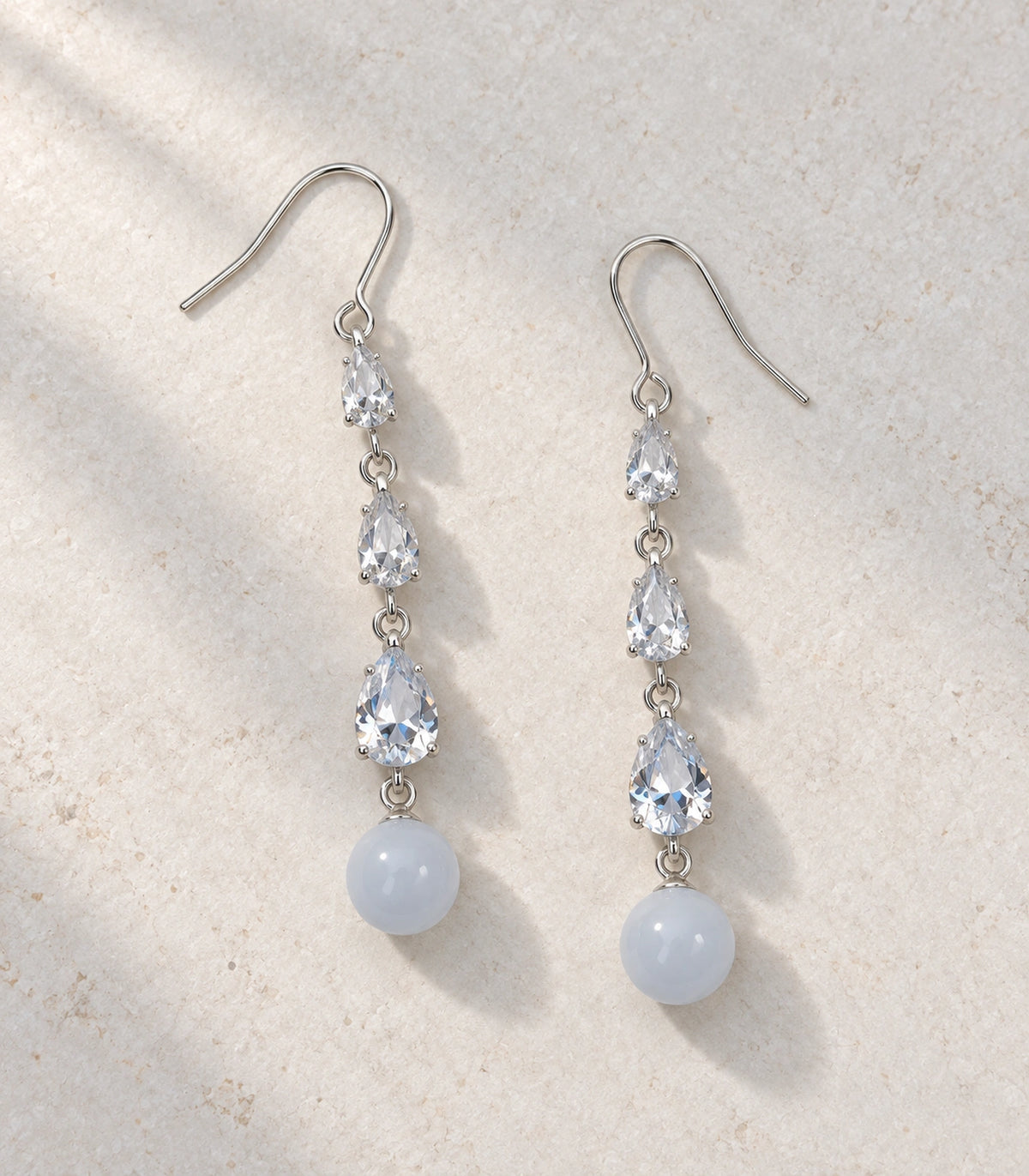 JIMIKI Silver Tone Three Pear White Bead Drop Earring Pair in Silver-tone, editorial flat lay