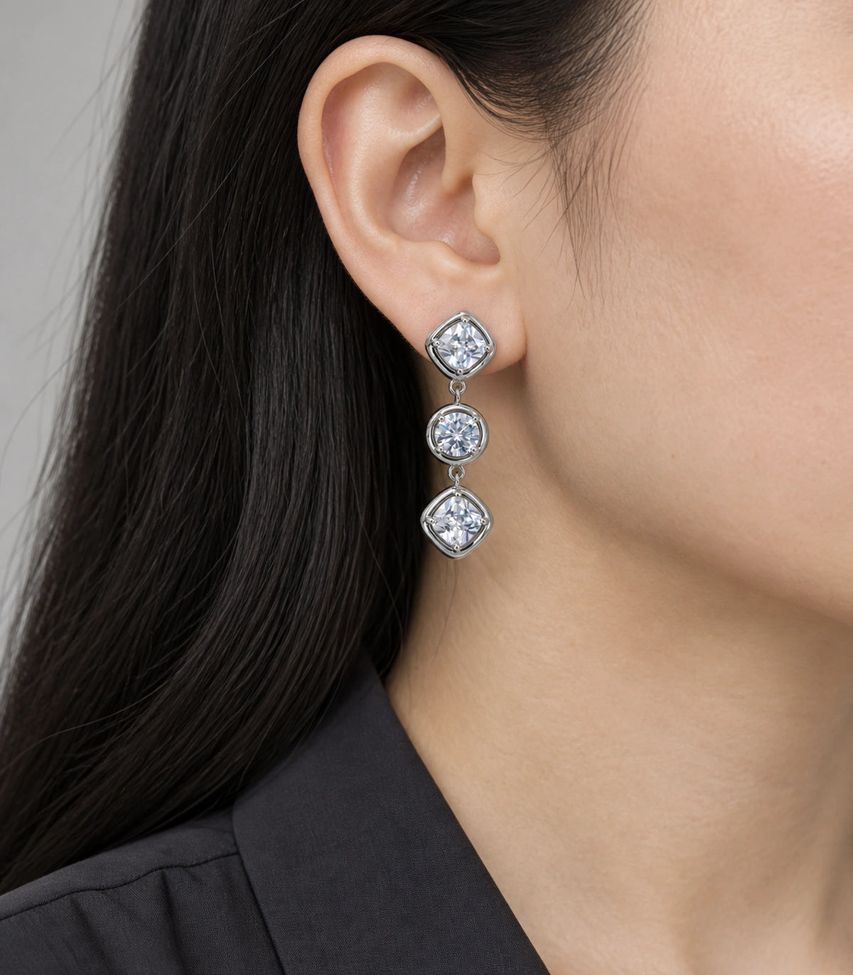 JIMIKI Three Stone Crystal Drop Earring Pair in Silver tone, model wearing view #color_silver tone