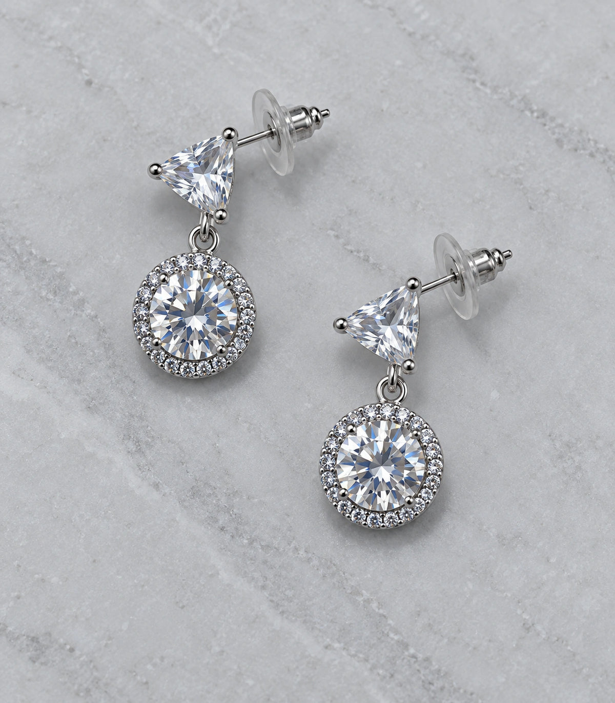 JIMIKI Triangle Round Halo Crystal Drop Earring Pair in Silver Tone, editorial flat lay #color_silver tone