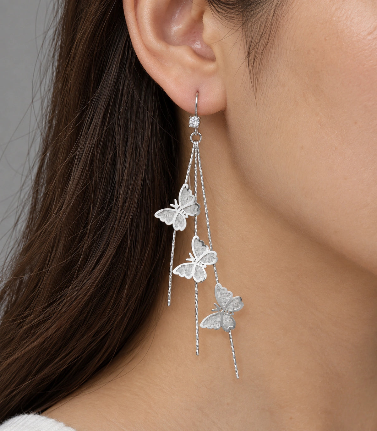 JIMIKI Silver-Tone Triple Butterfly Chain Drop Earrings in Silver Tone, close-up detail