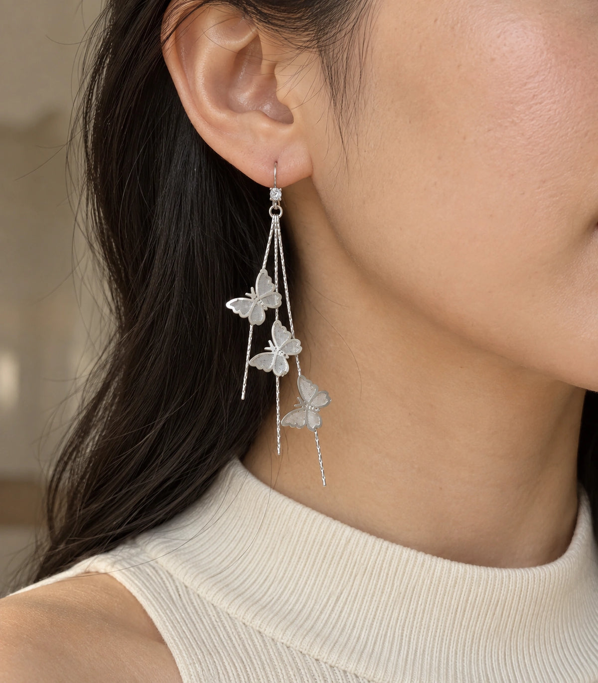 JIMIKI Silver-Tone Triple Butterfly Chain Drop Earrings in Silver Tone, editorial model view