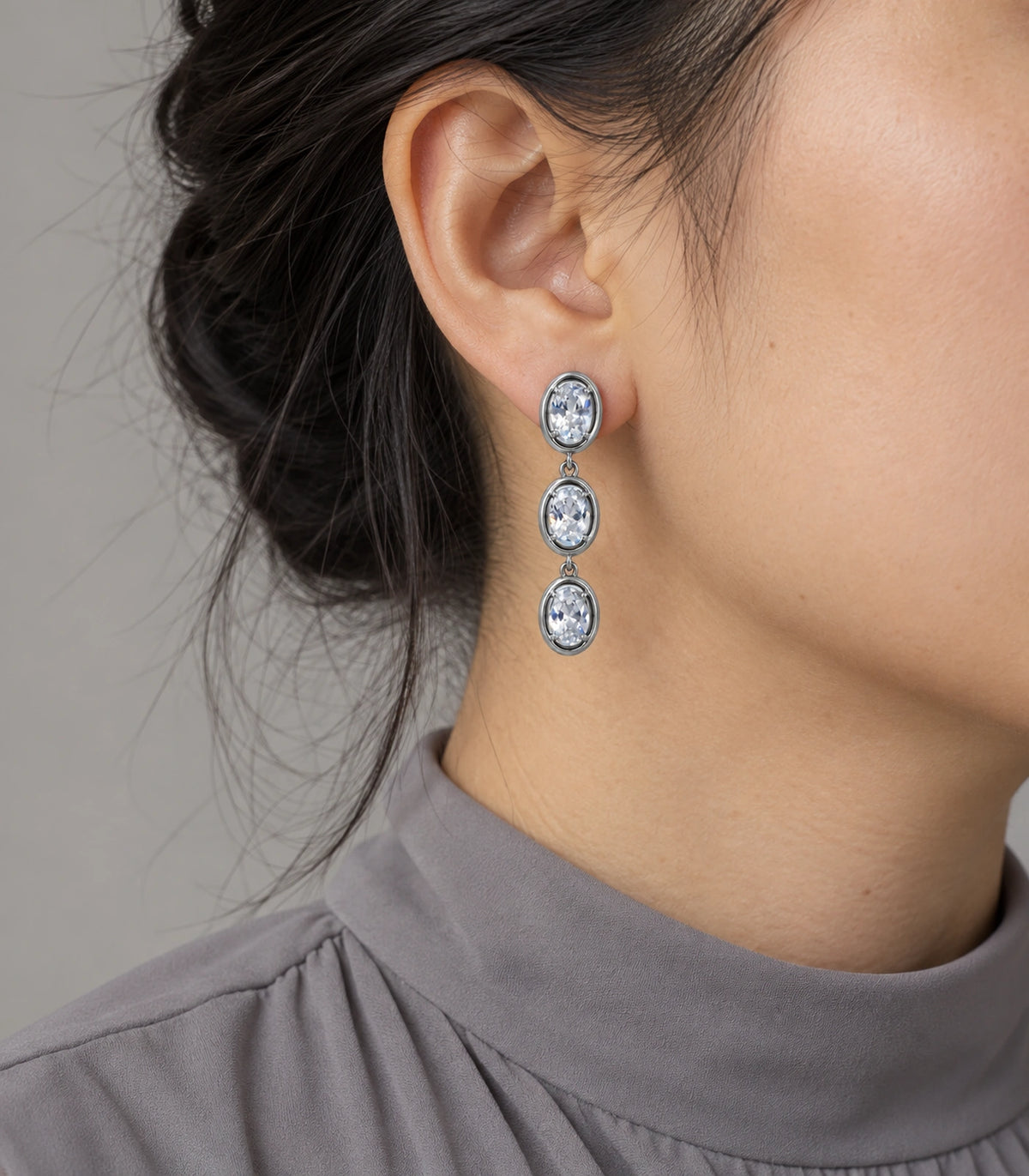 JIMIKI Triple Oval Crystal Drop Earring Pair in Silver tone, model wearing view #color_silver tone