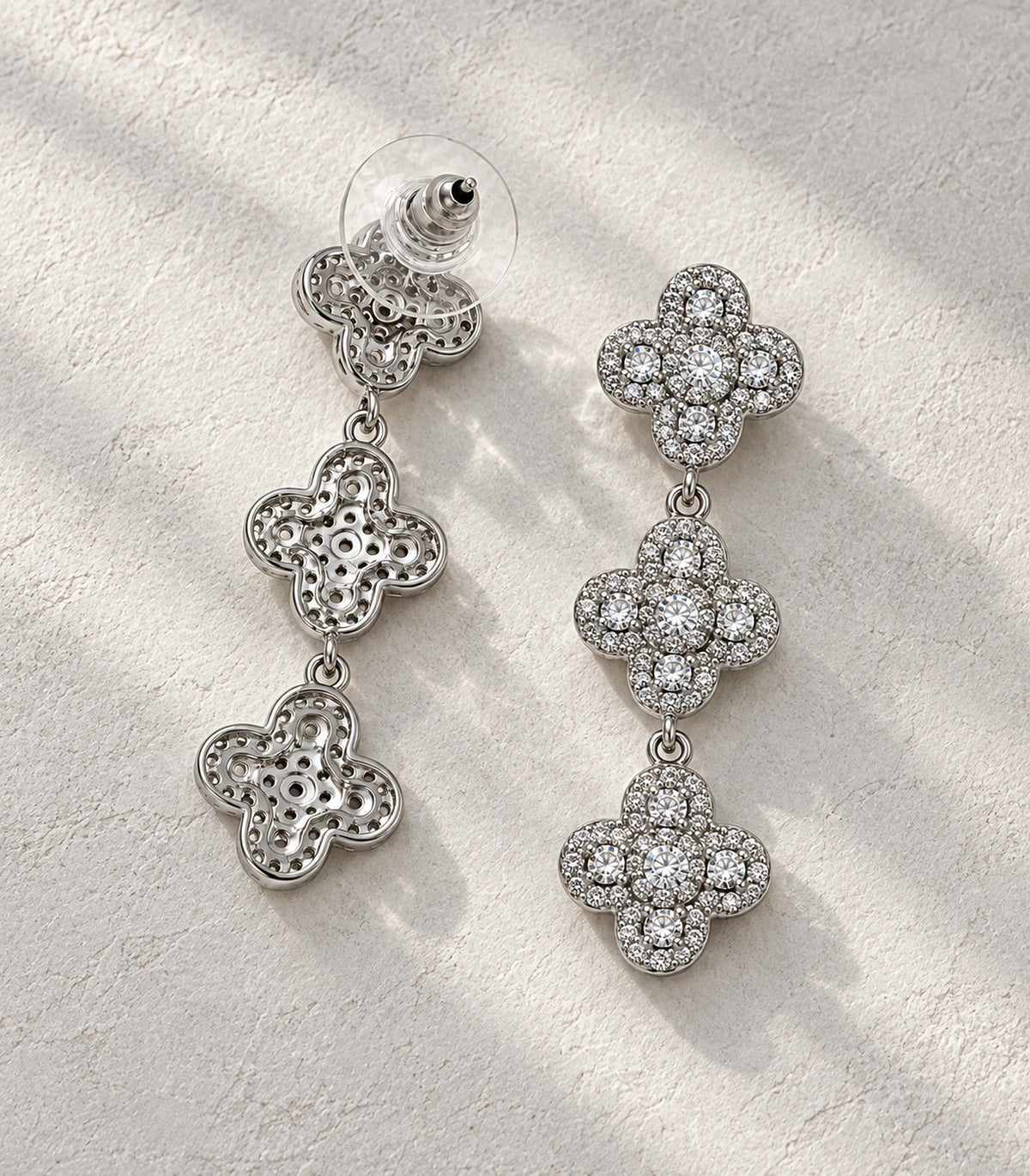 JIMIKI Pave Triple Quatrefoil Drop Earring Pair in Silver tone, editorial flat lay #color_silver tone