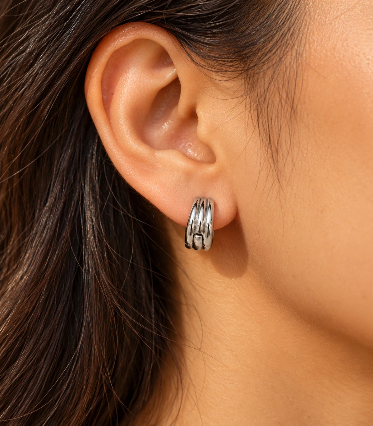 JIMIKI Triple-Ridge Huggie Hoop Earrings in Silver - editorial-model #color_silver