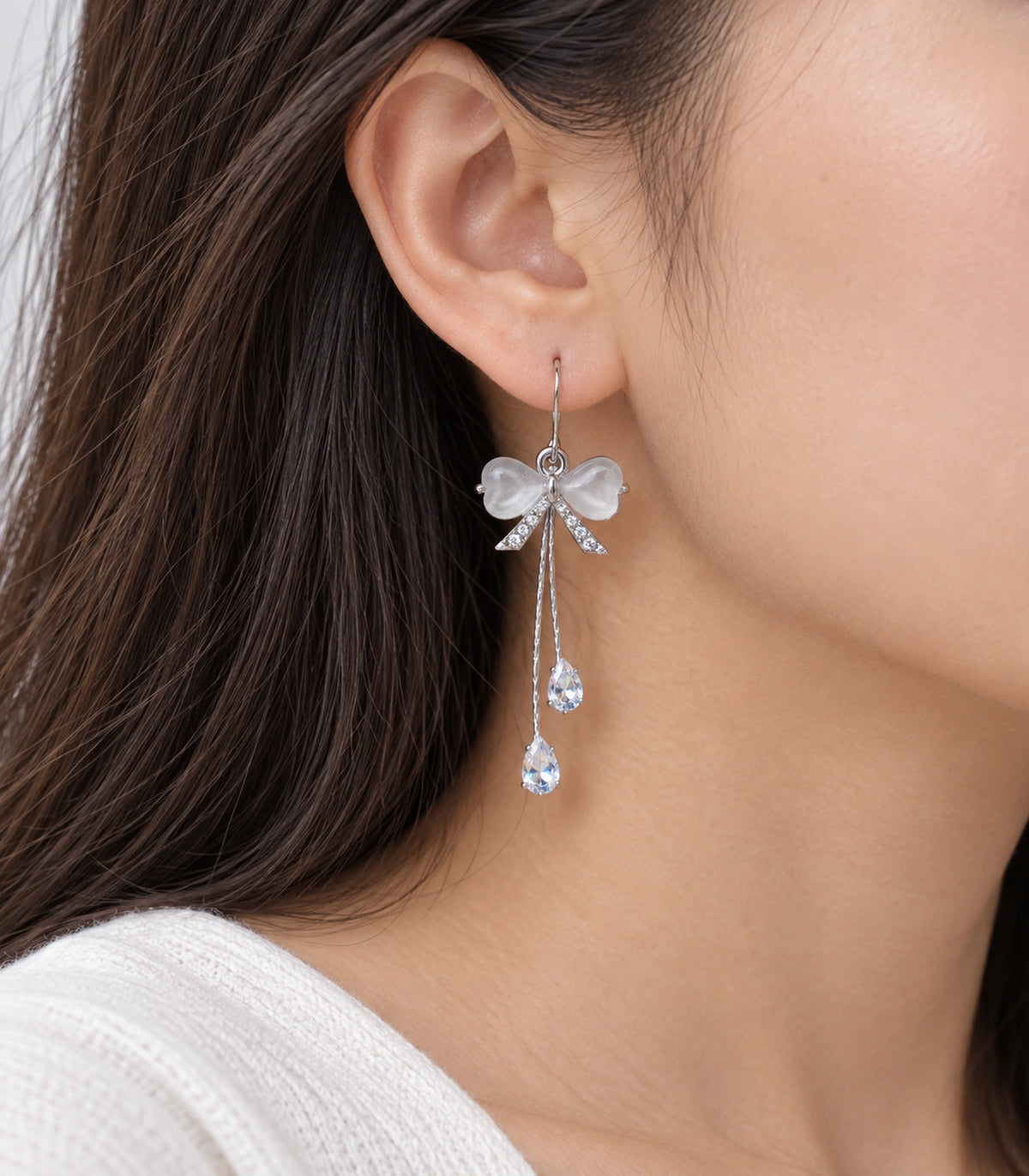 JIMIKI Silver Tone White Bow Twin Pear Chain Earring Pair in Silver-tone, model wearing view