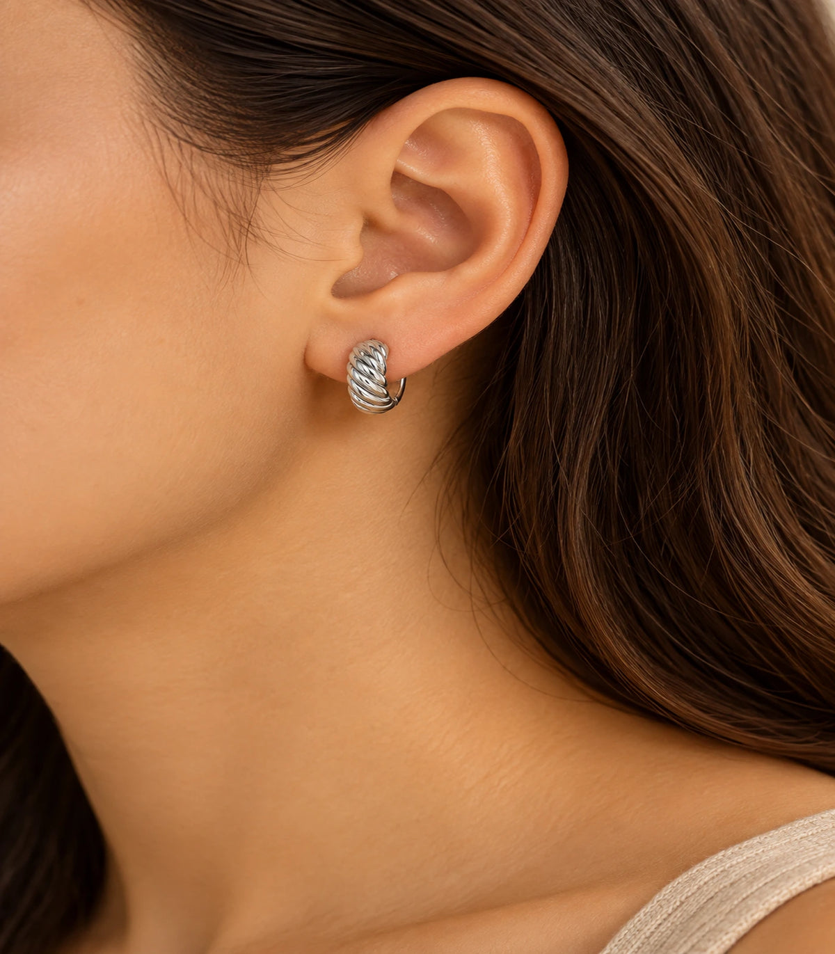 JIMIKI Twisted Rope Huggie Earrings in Silver — editorial worn styling #color_silver