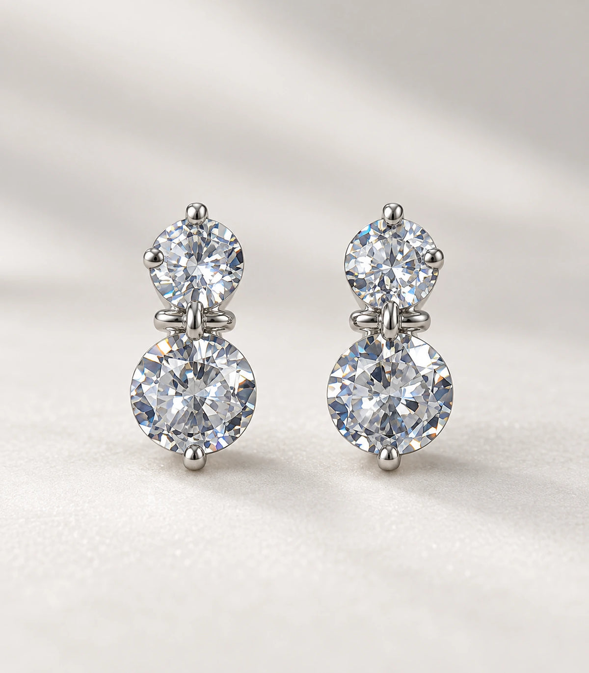 JIMIKI silver-tone two-round crystal drop earrings — closeup view