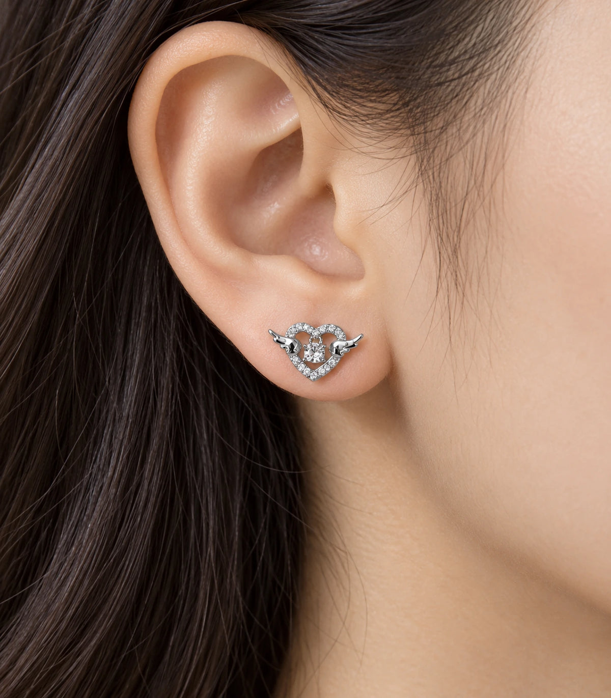 JIMIKI Winged Heart Crystal Stud Earrings in Silver — worn styling view #color_silver