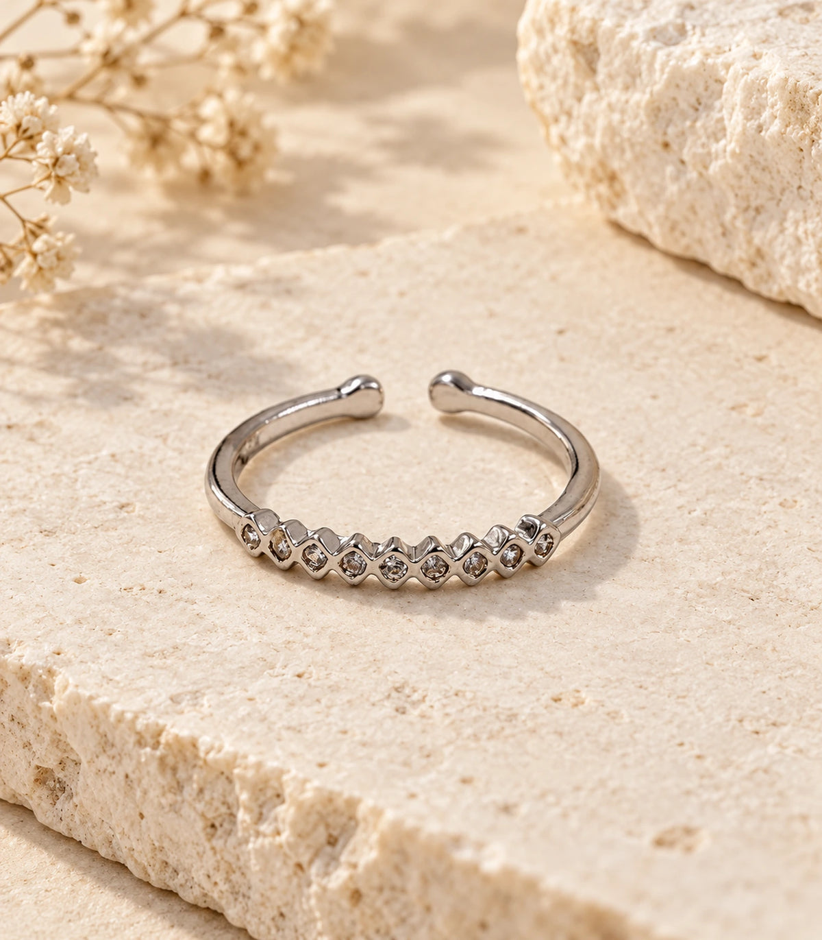 JIMIKI Silver Zigzag Crystal Band Ring in Silver - editorial flatlay #color_silver