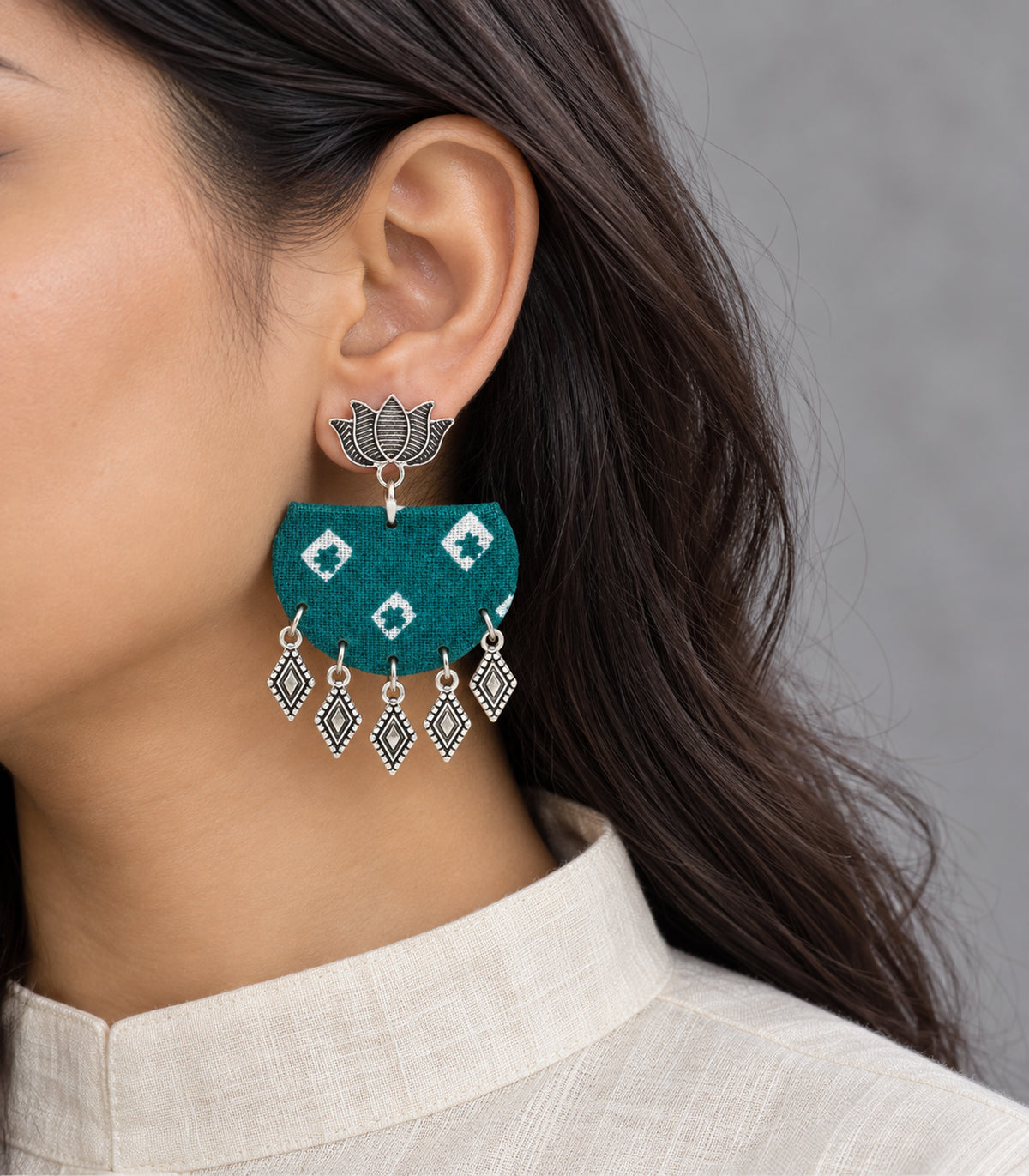 Teal fabric lotus diamond charm earrings - closeup view