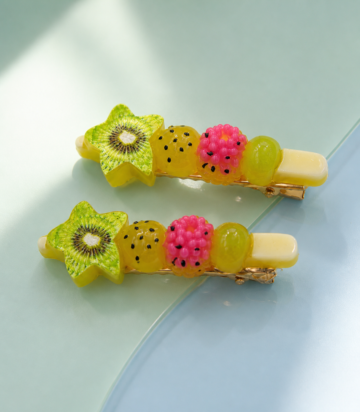 Tropical Fruit Skewer Barrette Pair in an editorial flat lay