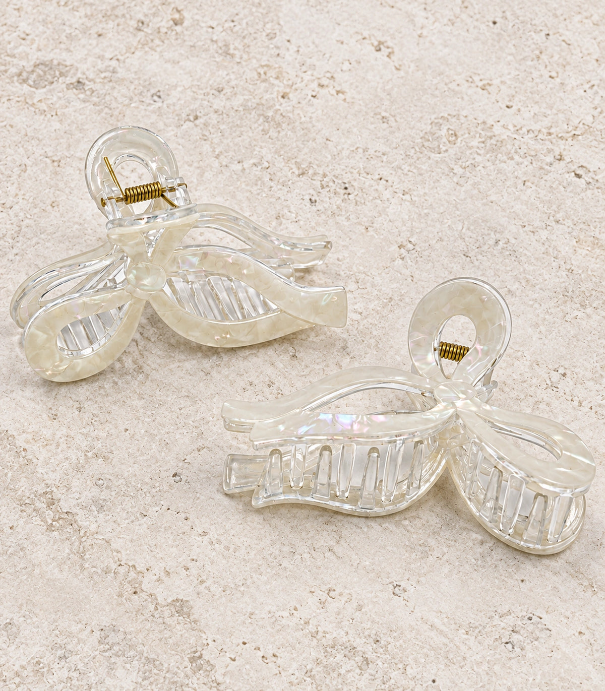 JIMIKI Iridescent Openwork Bow Hair Claw Clips in White, editorial flat lay #color_white