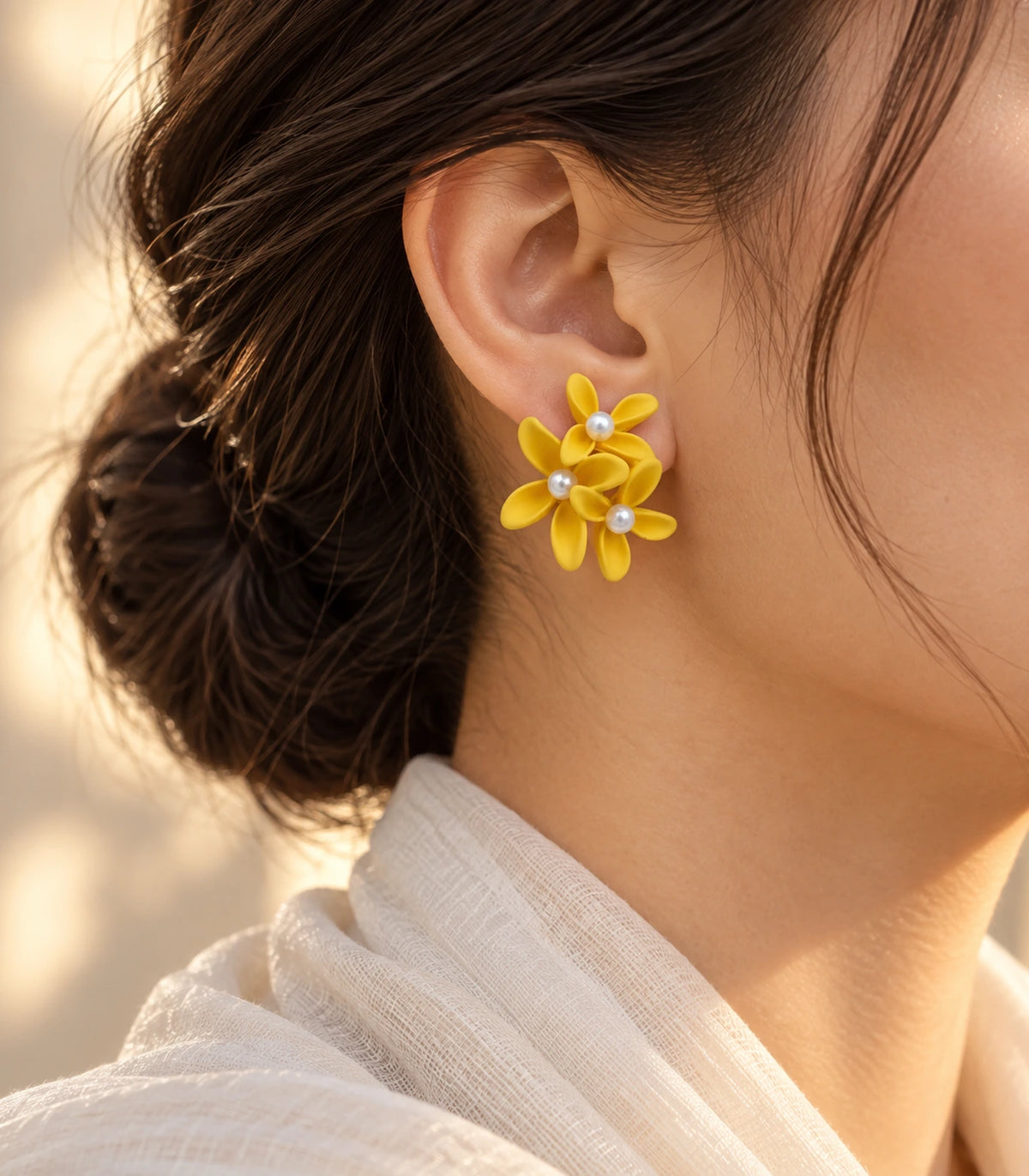 JIMIKI Yellow cascading floral cluster stud earrings, worn with softly lit editorial styling #color_yellow
