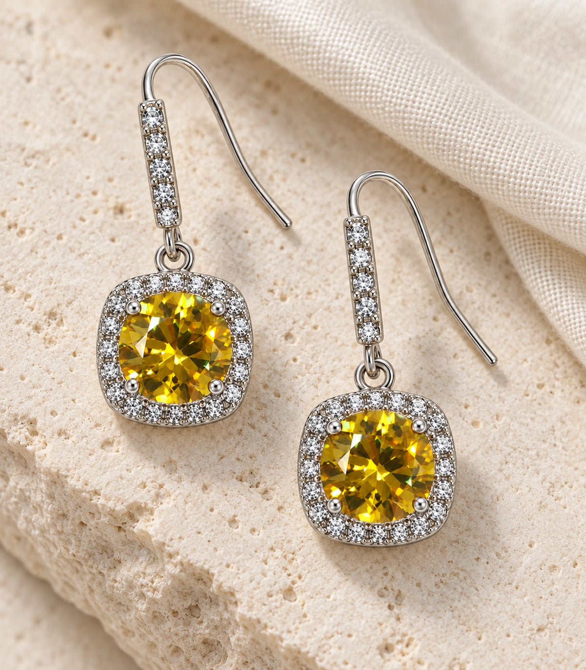 JIMIKI Crystal Cushion Halo Hook Earring Pair in Silver tone / yellow, editorial flat lay #color_silver tone / yellow