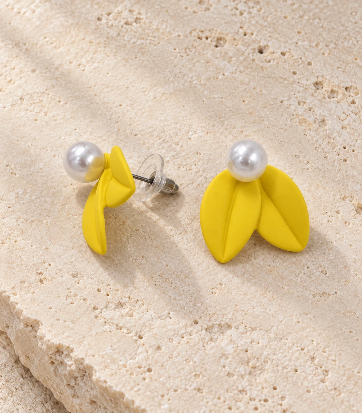JIMIKI Double Leaf Pearl Stud Earrings in Yellow — pair in a styled flat lay #color_yellow