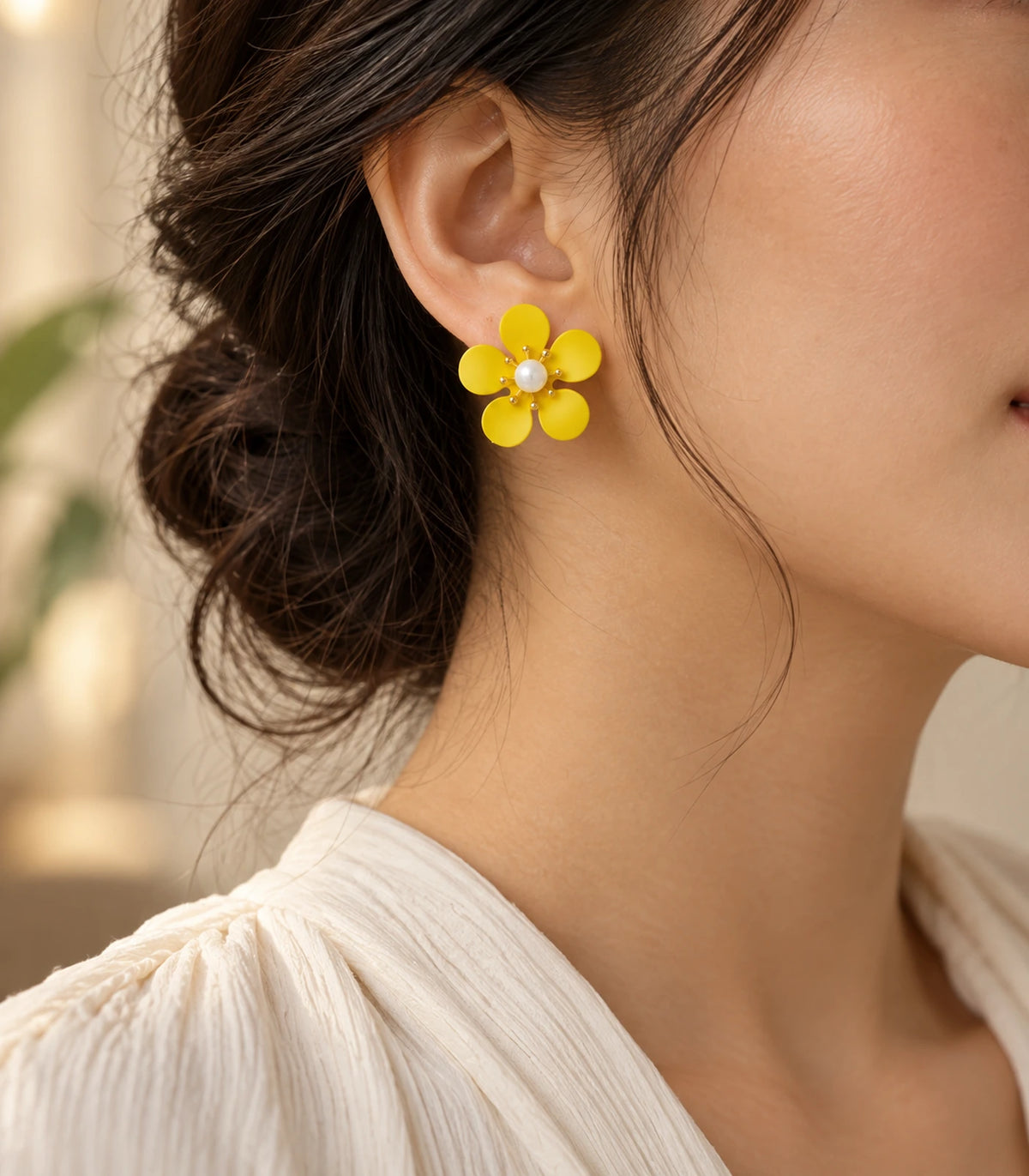 JIMIKI yellow five-petal flower stud earrings with pearl-effect centre, alternate styled worn view of flower stud #color_yellow