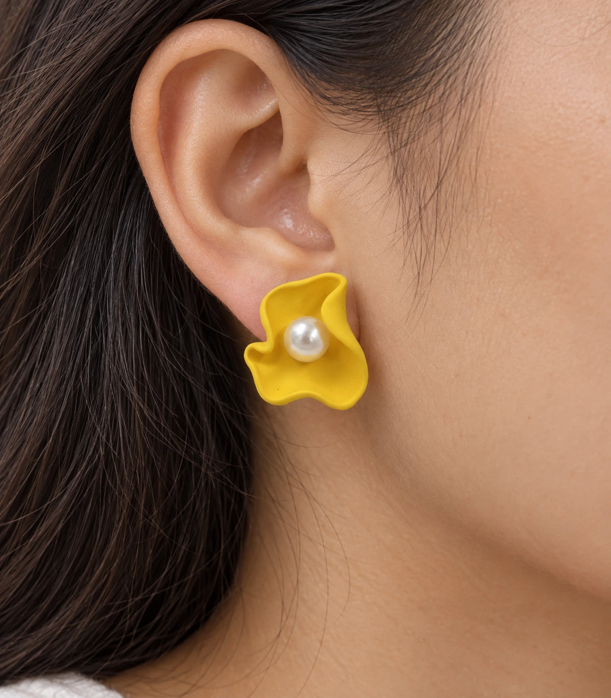 JIMIKI Folded Calla Pearl Stud Earrings, Yellow — worn close-up showing petal detail #color_yellow