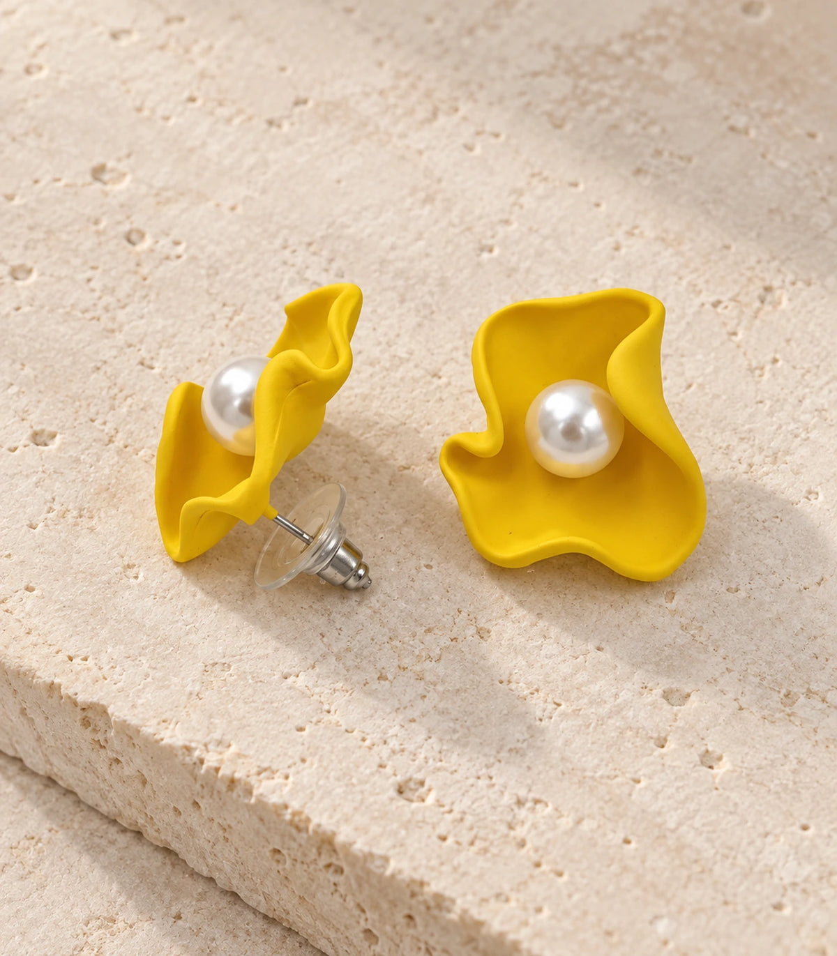 JIMIKI Folded Calla Pearl Stud Earrings, Yellow — pair in a styled flat lay #color_yellow