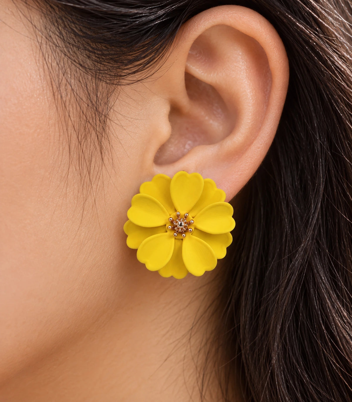 JIMIKI Yellow Layered Daisy Stud Earrings - layered scalloped petals and gold-tone centre worn close-up #color_yellow