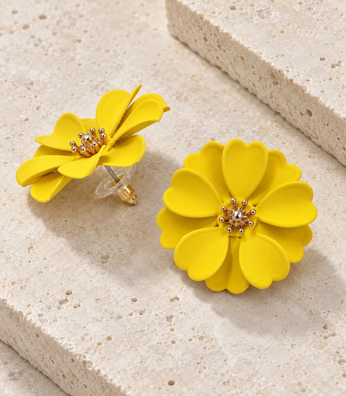 JIMIKI Yellow Layered Daisy Stud Earrings - pair in styled flatlay #color_yellow