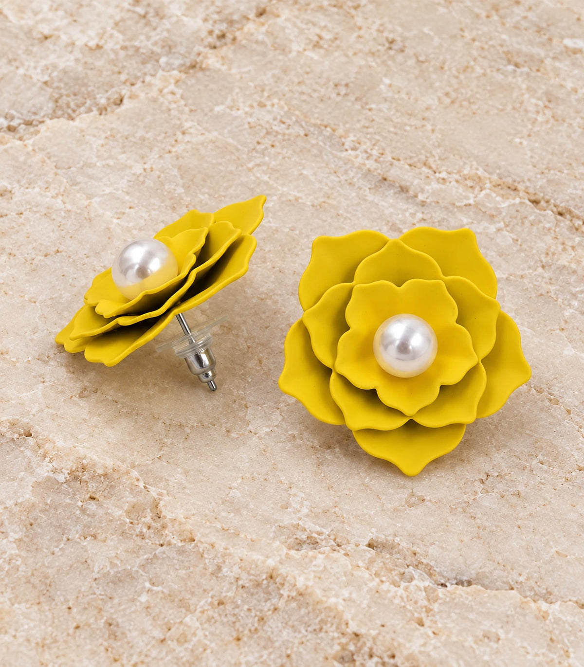 JIMIKI Layered Flower Pearl Stud Earrings, Yellow — pair in a styled flat lay #color_yellow
