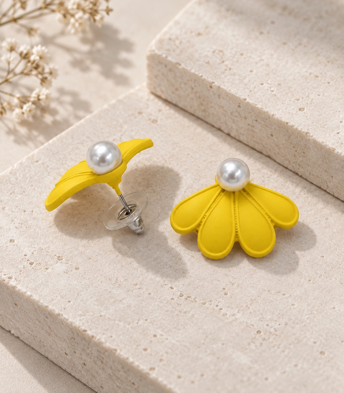 JIMIKI Yellow pearl fan petal stud earrings, pair in an editorial flat lay #color_yellow