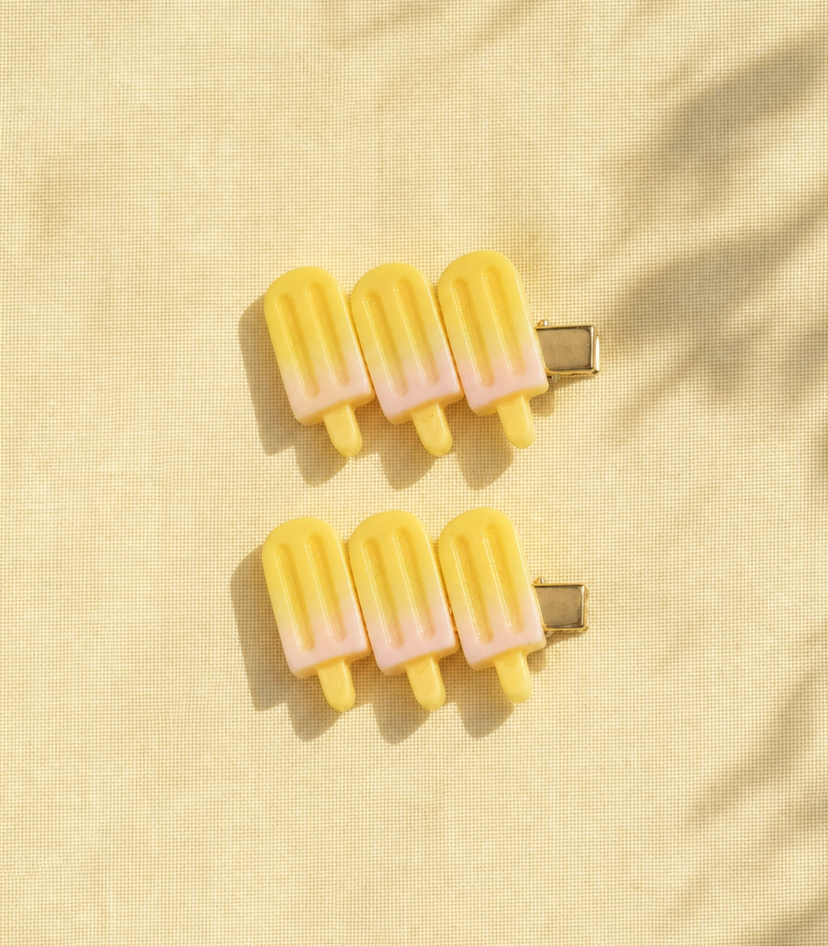 Yellow Popsicle Trio Clip Pair in an editorial flat lay
