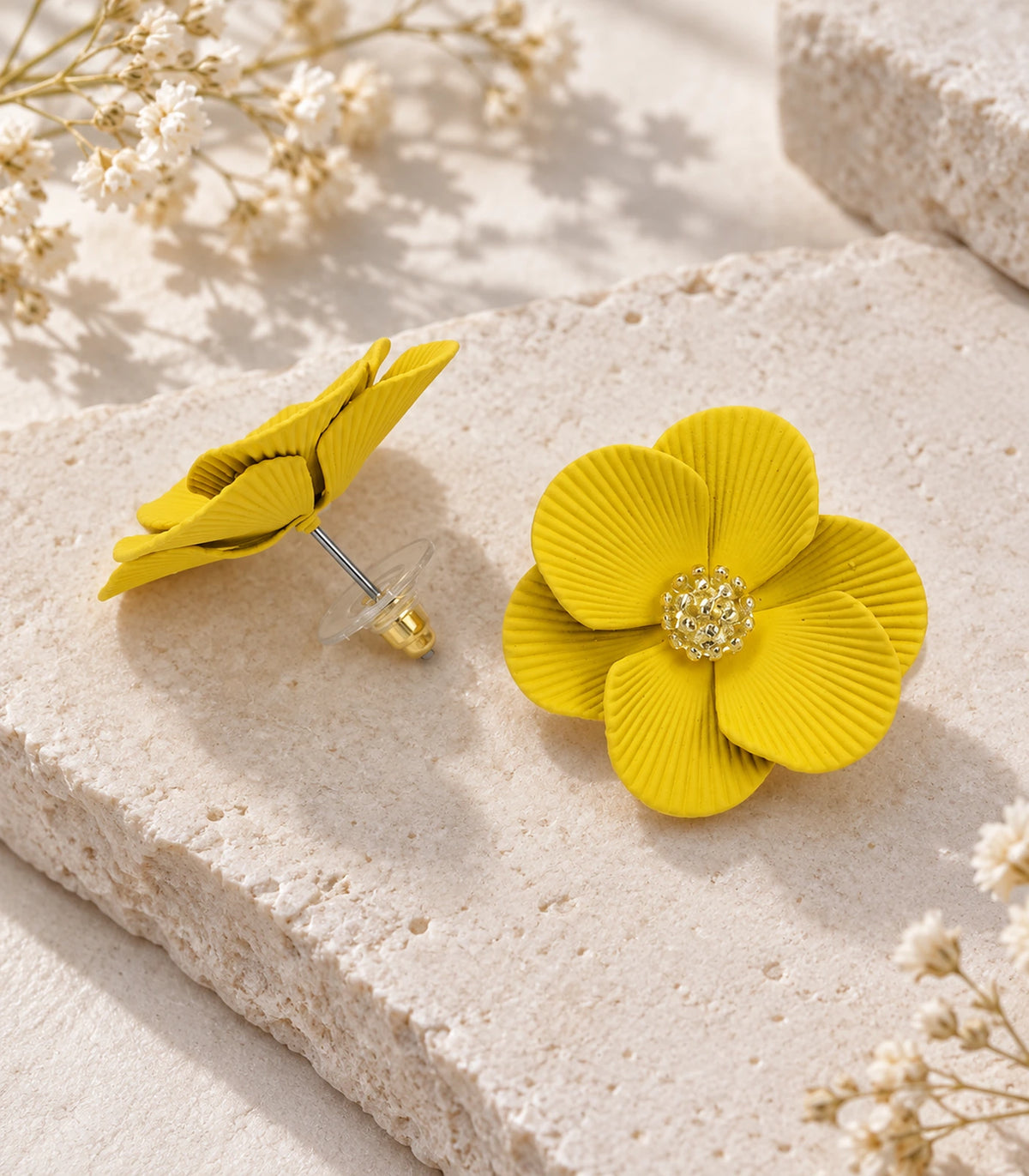 JIMIKI Yellow ribbed flower stud earrings, pair arranged in an editorial flat lay #color_yellow