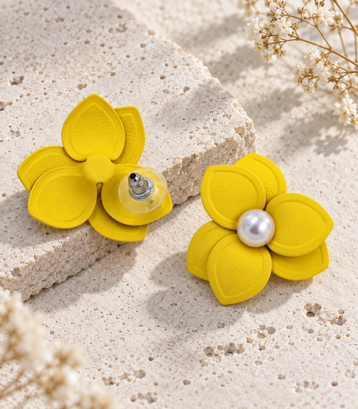 JIMIKI Yellow Triple Petal Pearl Flower Stud Earrings - pair in styled flat lay #color_yellow
