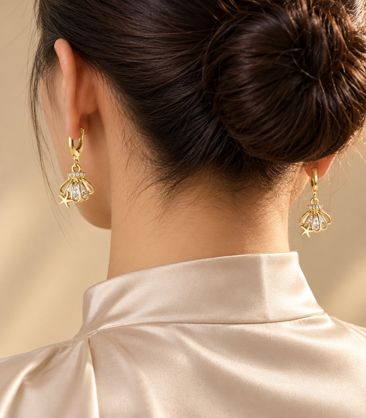 Editorial worn view of earrings from the gold-tone three-pair hoop set