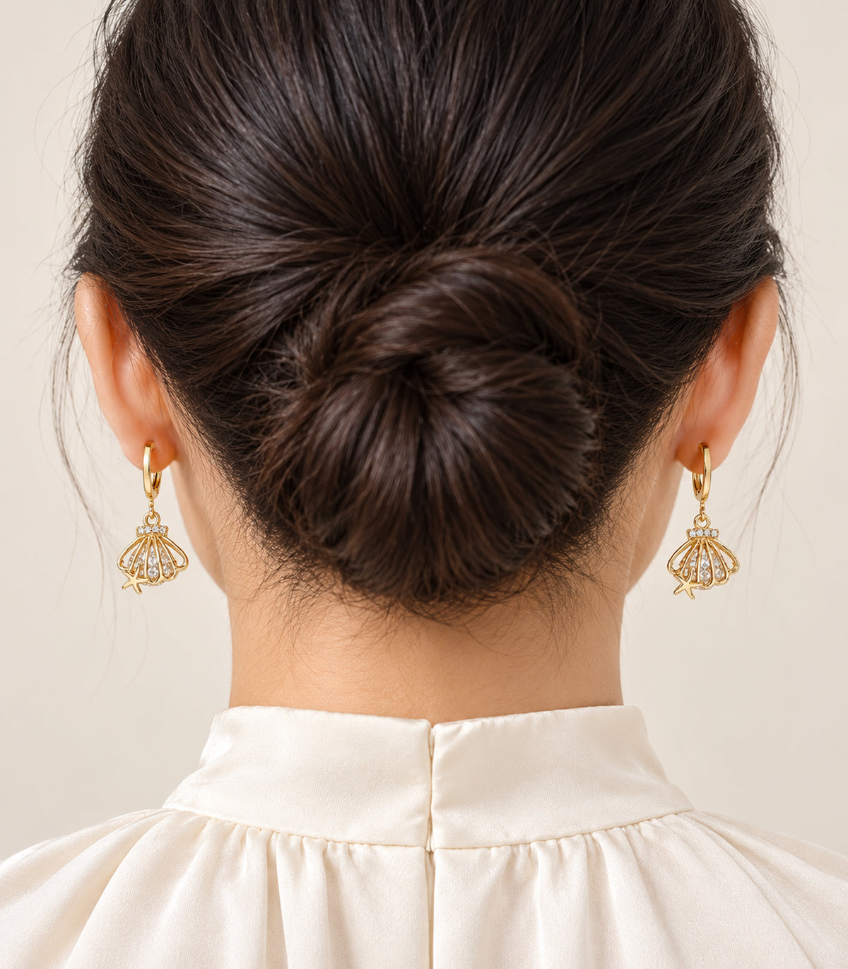 Worn pair from the gold-tone three-pair charm hoop earring set