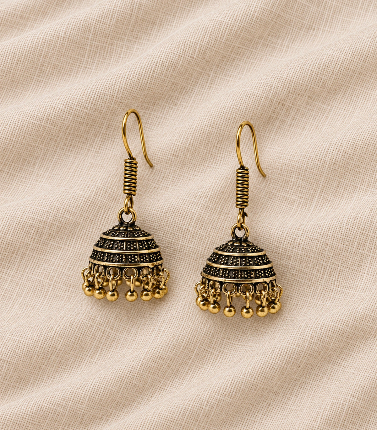 JIMIKI Antique Gold Banded Dotted Hook Jhumka Earrings in Antique Gold - editorial flatlay #color_antique-gold